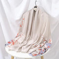 Champagne silk-satin scarf with peach cherry blossom floral print and light purple accents