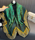 Emerald green silk-satin scarf featuring black floral patterns and a leopard print border with yellow trim