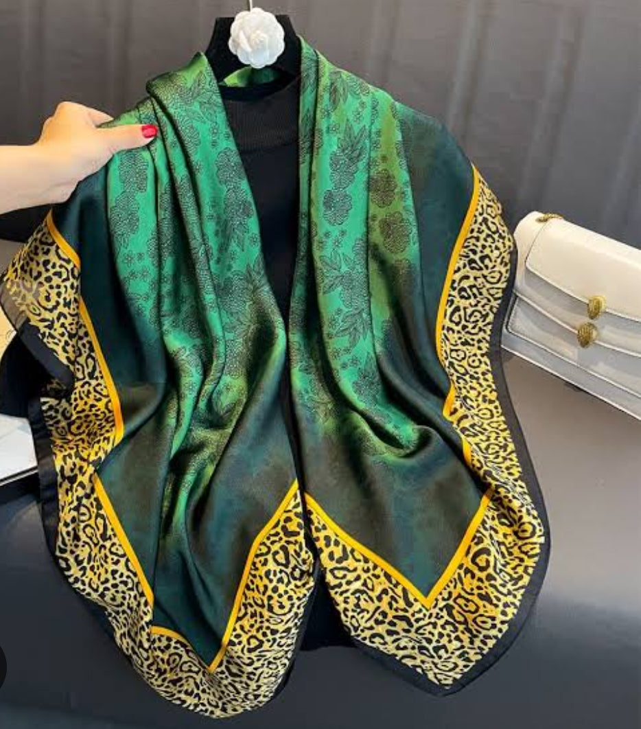 Emerald green silk-satin scarf featuring black floral patterns and a leopard print border with yellow trim