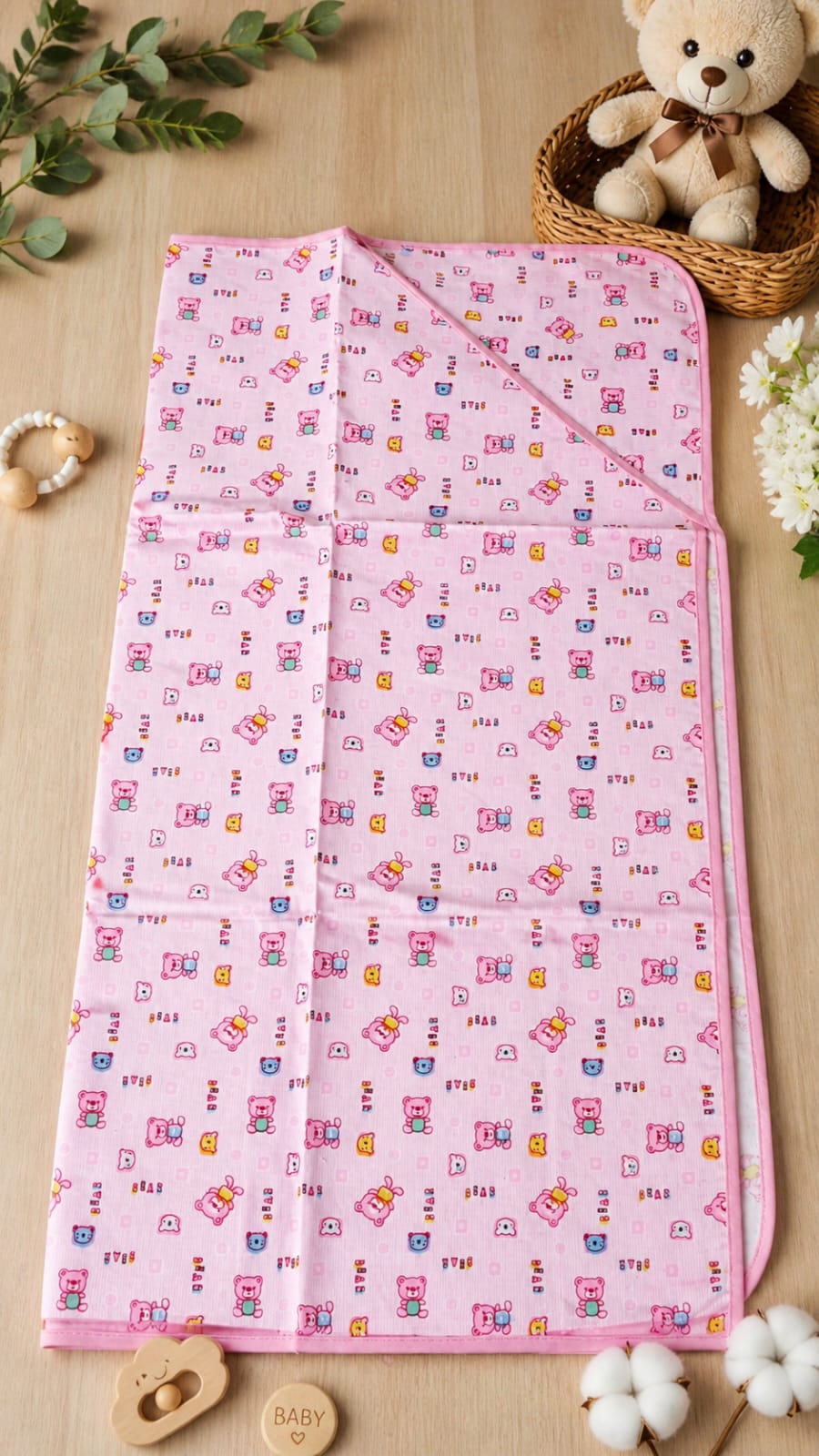 Pink hooded baby blanket with cute cartoon bear pattern.