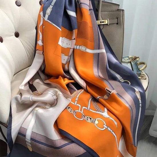 Orange and slate grey silk-satin scarf featuring a detailed equestrian belt and buckle print