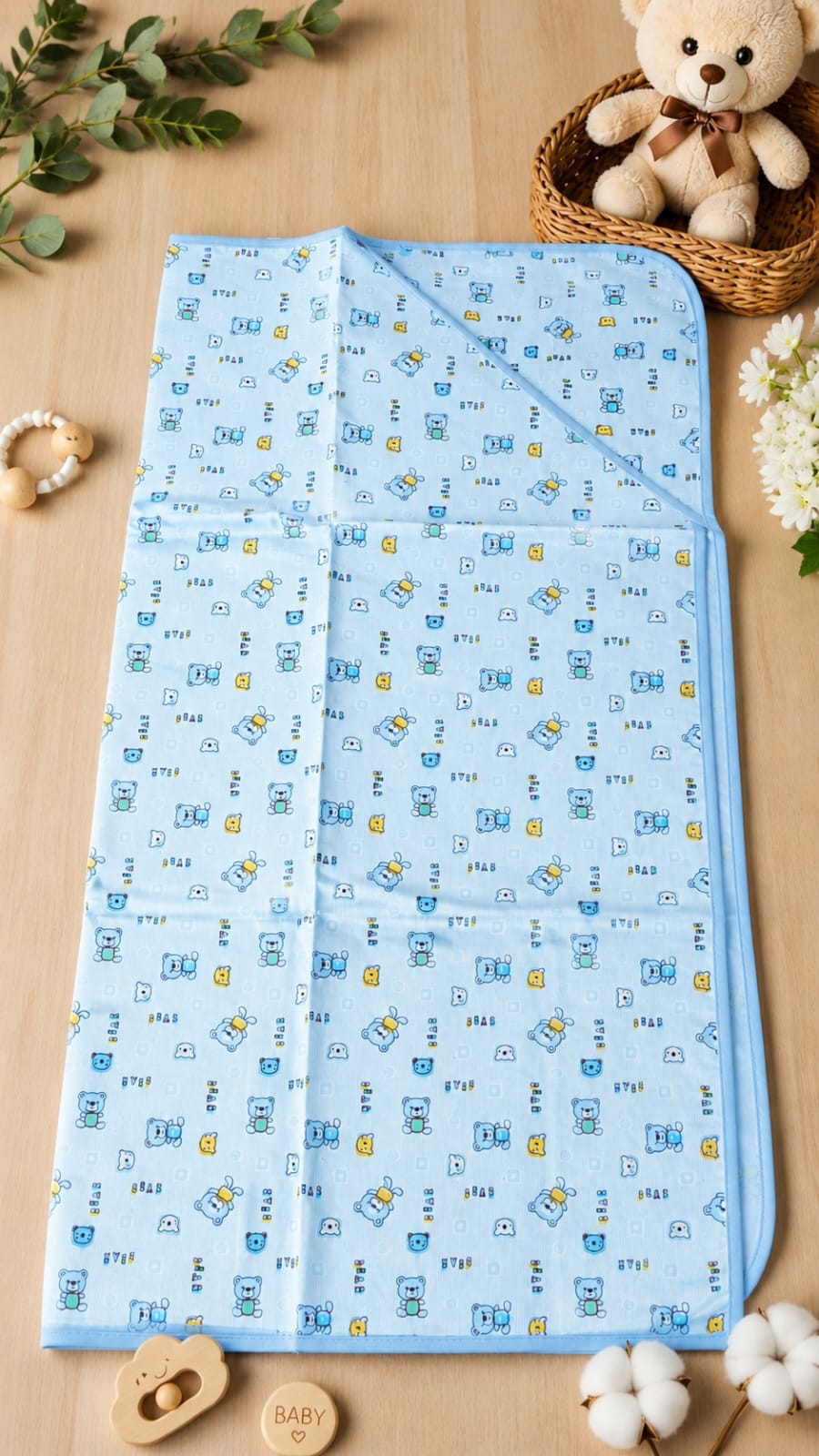 Blue hooded baby blanket with cute cartoon bear pattern.