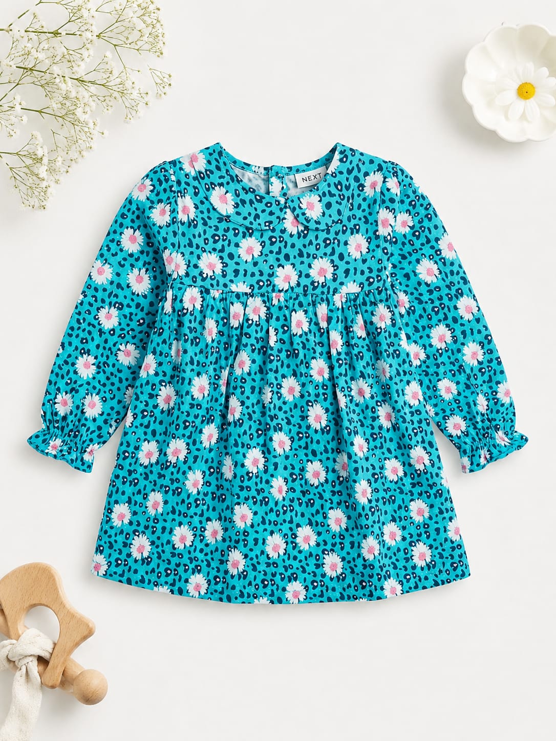 Teal long-sleeve toddler dress with white daisy floral and leopard print pattern.