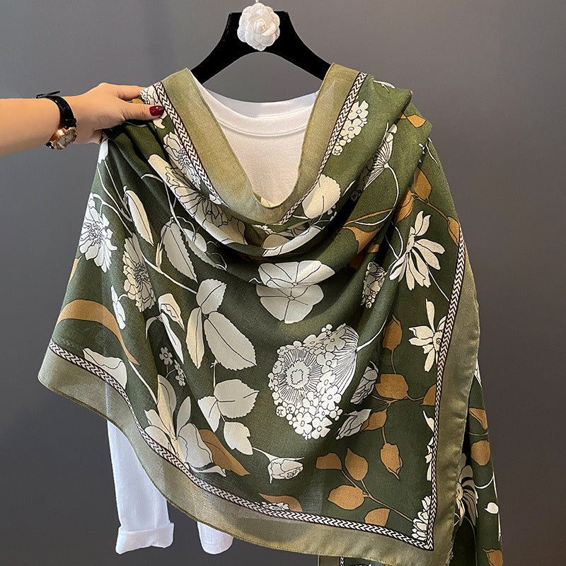 Olive green silk-satin scarf featuring a large white and brown botanical floral pattern with a decorative patterned border